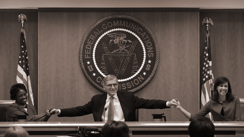 The three democratic members of the FCC linking hands in celebration of adopting Net Neutrality in 2015.
