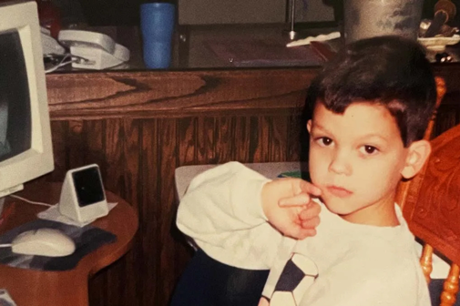 A young Mike sits at the family computer in the late 90s.